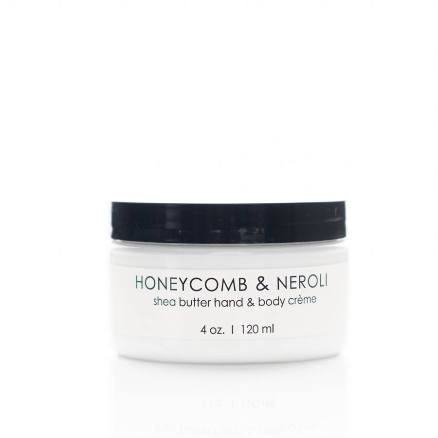 A white jar with a black lid labeled "Honeycomb & Neroli Shea Butter Hand & Body Crème." The jar contains 4 oz (120 ml) of product, prominently displayed on a white background.